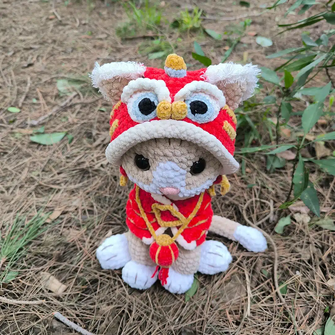 Chat au crochet et son habit rouge de dragon vu de dessus